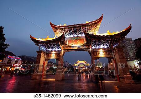 Night view of memorial arches of the Golden Horse and Jade Rooster in Jinmabiji Square, Kunming, China View Large Photo Image Stock Photo - Night view of memorial arches of the Golden Horse and Jade Rooster in Jinmabiji Square, Kunming, China. Fotosearch