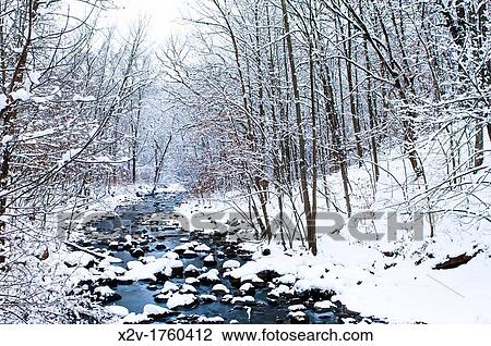 Stock Image - Nine Mile Creek flowing to the Minnesota River after a winter snow storm. Fotosearch