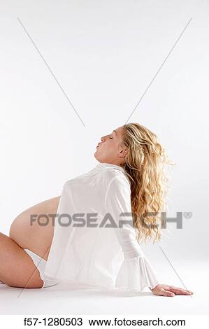 Stock Image - Nine months pregnant mother to be. Fotosearch