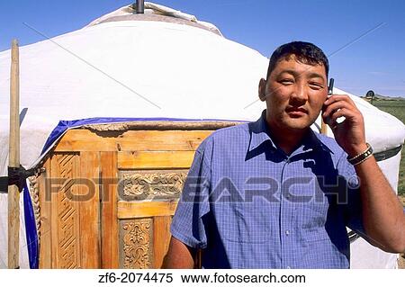 Nomadic Villager next to Ger on Cell Phone in Mongolia. View Large Photo Image Stock Photography - Nomadic Villager next to Ger on Cell Phone in Mongolia.. Fotosearch