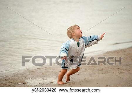 Noosa, Queensland, Australia, a young boy running and tripping on the beach. View Large Photo Image Stock Photo - Noosa, Queensland, Australia, a young boy running and tripping on the beach.. Fotosearch