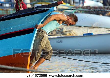 North Africa, Tunisia, Hammamet, fisherman returning his boat View Large Photo Image Stock Photograph - North Africa, Tunisia, Hammamet, fisherman returning his boat. Fotosearch