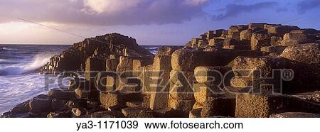 NORTHERN IRELAND, County Antrim, Giants Causeway Waves crash against the hexagonal basalts rock formations of this world heritage site View Large Photo Image Stock Photo - NORTHERN IRELAND, County Antrim, Giants Causeway Waves crash against the hexagonal basalts rock formations of this world heritage site. Fotosearch