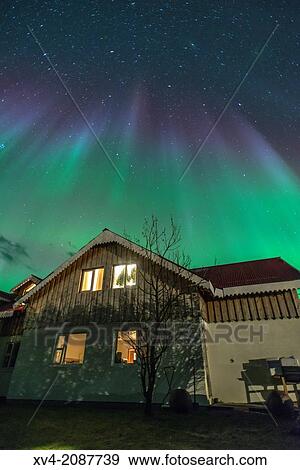 Stock Photo - Northern lights above small village of Bleidabollstadur, Vatnajokull National Park, Iceland.. Fotosearch