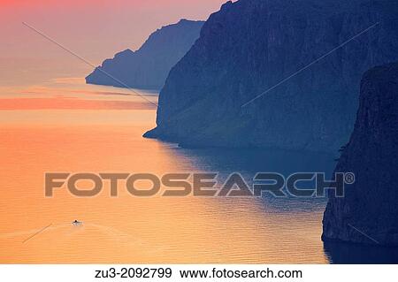 Northwest coast of Majorca and fishing boat at sunrise, La Calobra area. Punta Beca cape. Balearic islands, Spain View Large Photo Image Stock Photo - Northwest coast of Majorca and fishing boat at sunrise, La Calobra area. Punta Beca cape. Balearic islands, Spain. Fotosearch