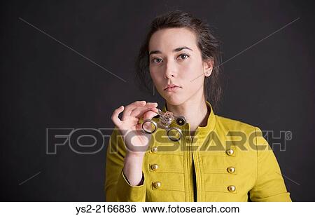 Nostalgic retro styled portrait of serious woman holding opera glasses. View Large Photo Image Stock Photograph - Nostalgic retro styled portrait of serious woman holding opera glasses.. Fotosearch
