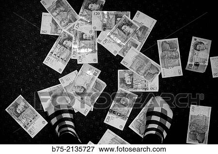 Notes of 10, 20 and 50 pounds in the floor and feet with treading socks. England, UK, Europe. View Large Photo Image Stock Photo - Notes of 10, 20 and 50 pounds in the floor and feet with treading socks. England, UK, Europe.. Fotosearch
