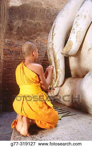 Novice monk Praying Buddha at temple Wat Si Chum. Sukhothai. Thailand View Large Photo Image Stock Photo - Novice monk Praying Buddha at temple Wat Si Chum. Sukhothai. Thailand. Fotosearch