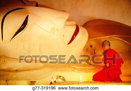 Novice monk praying buddha. Bagan. Myanmar (Burma) View Large Photo Image Stock Photograph - Novice monk praying buddha. Bagan. Myanmar (Burma). Fotosearch