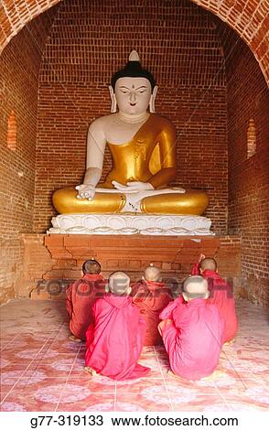 Novice monks praying buddha. Bagan. Myanmar (Burma) View Large Photo Image Stock Image - Novice monks praying buddha. Bagan. Myanmar (Burma). Fotosearch