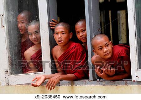Novices looking out of a window, Burma. View Large Photo Image Stock Image - Novices looking out of a window, Burma.. Fotosearch