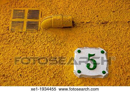 Stock Photography - number 5, yellow wall, Reus. Fotosearch