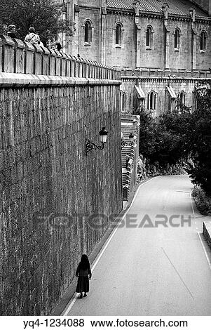 Stock Photo - Nun walking in the vicinity of the Basilica de Covadonga, Asturias. Fotosearch