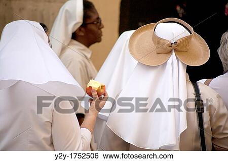Nun with apple and nun with original hut in Caballeros Street, in Valencia, Spain. View Large Photo Image Stock Photograph - Nun with apple and nun with original hut in Caballeros Street, in Valencia, Spain.. Fotosearch
