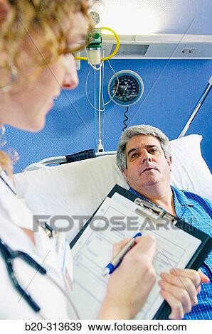 Nurse and patient in hospital room View Large Photo Image Stock Photo - Nurse and patient in hospital room. Fotosearch