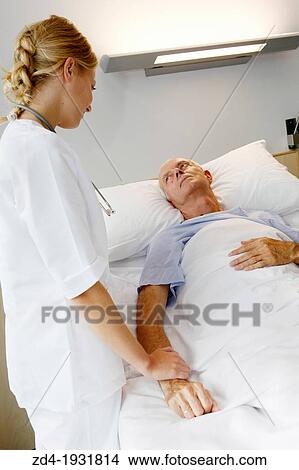 Picture - Nurse attending to patient in hospital room, Onkologikoa Hospital, Oncology Institute, Case Center for prevention, diagnosis and treatment of cancer, Donostia, San Sebastian, Gipuzkoa, Basque Country, Spain. Fotosearch