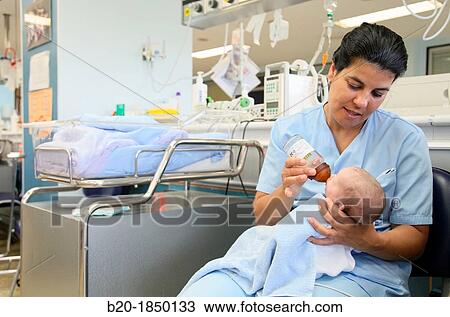 Stock Image - Nurse care, Neonate Intensive care Unit, Donostia Hospital, San Sebastian, Donostia, Gipuzkoa, Basque Country, Spain. Fotosearch