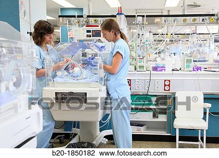 Stock Image - Nurse care, Neonate Intensive care Unit, Donostia Hospital, San Sebastian, Donostia, Gipuzkoa, Basque Country, Spain. Fotosearch