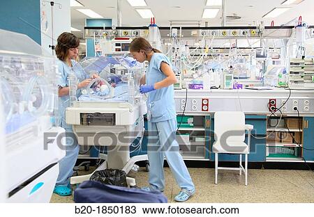 Stock Image - Nurse care, Neonate Intensive care Unit, Donostia Hospital, San Sebastian, Donostia, Gipuzkoa, Basque Country, Spain. Fotosearch