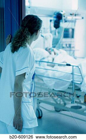 Nurse looking at interior of ICU, Intensive Care Unit View Large Photo Image Stock Photograph - Nurse looking at interior of ICU, Intensive Care Unit. Fotosearch