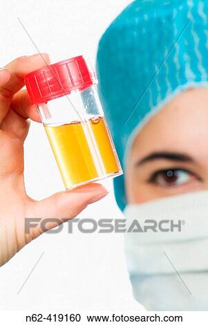 Nurse looks at a tube that takes urine with the index finger and thumb View Large Photo Image Stock Image - Nurse looks at a tube that takes urine with the index finger and thumb. Fotosearch