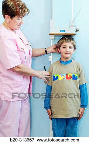 Nurse measuring 6 year old boy at pediatrics section of hospital View Large Photo Image Stock Photo - Nurse measuring 6 year old boy at pediatrics section of hospital. Fotosearch
