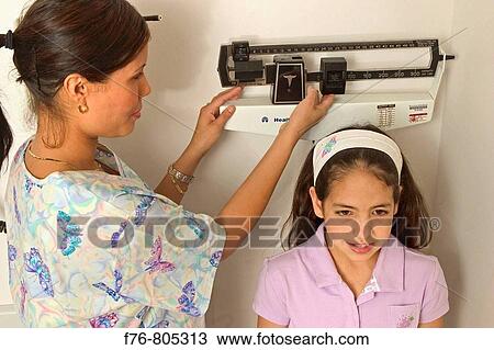Nurse, measuring height of young girl View Large Photo Image Stock Image - Nurse, measuring height of young girl. Fotosearch