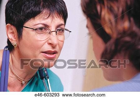 Nurse talking to patient at hospital View Large Photo Image Stock Image - Nurse talking to patient at hospital. Fotosearch