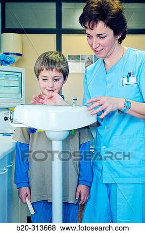 Nurse weighing 6 year old boy at pediatrics section of hospital View Large Photo Image Stock Photo - Nurse weighing 6 year old boy at pediatrics section of hospital. Fotosearch