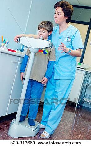 Nurse weighing 6 year old boy at pediatrics section of hospital View Large Photo Image Stock Photo - Nurse weighing 6 year old boy at pediatrics section of hospital. Fotosearch