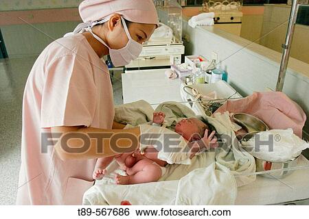 Stock Photograph - Nurse with new born baby. Fotosearch