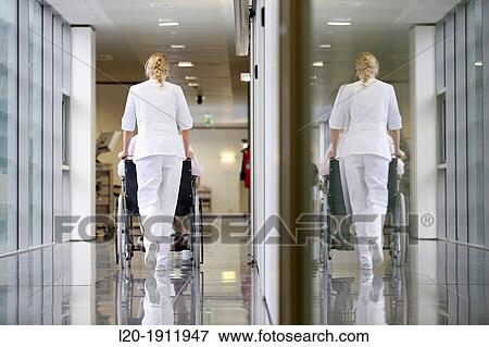 Stock Photo - Nurse with patient in wheelchair, Corridor, Onkologikoa Hospital, Oncology Institute, Case Center for prevention, diagnosis and treatment of cancer, Donostia, San Sebastian, Gipuzkoa, Basque Country, Spain. Fotosearch