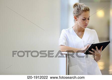 Nurse with tablet in corridor, Onkologikoa Hospital, Oncology Institute, Case Center for prevention, diagnosis and treatment of cancer, Donostia, San Sebastian, Gipuzkoa, Basque Country, Spain View Large Photo Image Stock Image - Nurse with tablet in corridor, Onkologikoa Hospital, Oncology Institute, Case Center for prevention, diagnosis and treatment of cancer, Donostia, San Sebastian, Gipuzkoa, Basque Country, Spain. Fotosearch