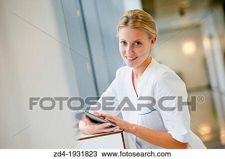 Nurse with tablet in corridor, Onkologikoa Hospital, Oncology Institute, Case Center for prevention, diagnosis and treatment of cancer, Donostia, San Sebastian, Gipuzkoa, Basque Country, Spain View Large Photo Image Stock Image - Nurse with tablet in corridor, Onkologikoa Hospital, Oncology Institute, Case Center for prevention, diagnosis and treatment of cancer, Donostia, San Sebastian, Gipuzkoa, Basque Country, Spain. Fotosearch