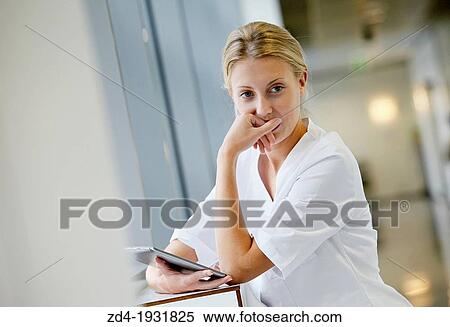 Stock Photography - Nurse with tablet in corridor, Onkologikoa Hospital, Oncology Institute, Case Center for prevention, diagnosis and treatment of cancer, Donostia, San Sebastian, Gipuzkoa, Basque Country, Spain. Fotosearch