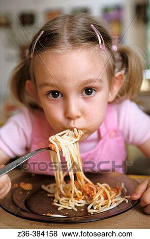 Nursery school. Gir eating spaghetti View Large Photo Image Stock Photo - Nursery school. Gir eating spaghetti. Fotosearch