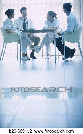 Stock Image - Nurses and doctors at coffee shop of hospital. Fotosearch