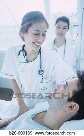 Nurses and patient at hospital View Large Photo Image Stock Photo - Nurses and patient at hospital. Fotosearch