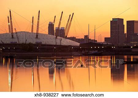 Stock Photo - O2 Arena and Canary Wharf buildings reflecting in Royal Victoria Docks, Newham, London, England, UK. Fotosearch
