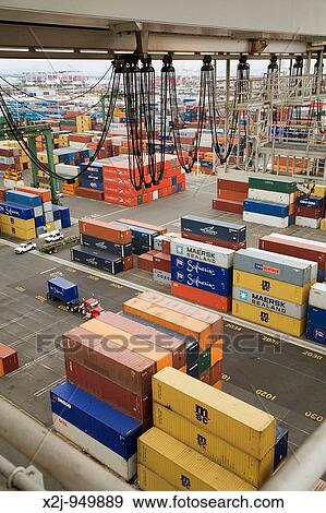 Oakland, California - Shipping containers await loading on container ships in the Port of Oakland The cables at top hang from a crane used to move the containers View Large Photo Image Stock Photo - Oakland, California - Shipping containers await loading on container ships in the Port of Oakland The cables at top hang from a crane used to move the containers. Fotosearch