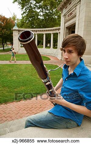 Oberlin, Ohio - Music student Wade Coufal plays his bassoon on the campus of Oberlin College View Large Photo Image Stock Photography - Oberlin, Ohio - Music student Wade Coufal plays his bassoon on the campus of Oberlin College. Fotosearch