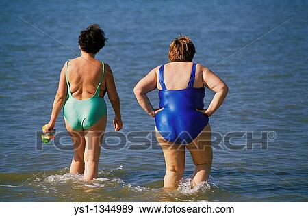 OBESE WOMEN ENTERING SEA View Large Photo Image Stock Photo - OBESE WOMEN ENTERING SEA. Fotosearch