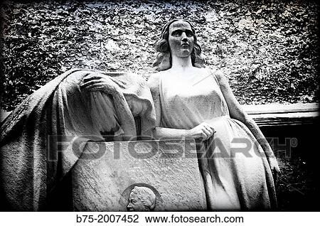 Stock Image - obituary sculpture of Paris Montparnasse Cemetery, France. Fotosearch
