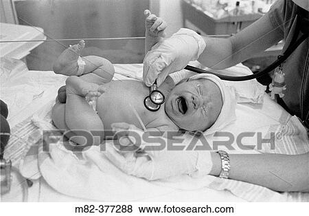 October 2003 -- Newborn baby has heart checked by nurse at a hospital in New York City. View Large Photo Image Stock Photo - October 2003 -- Newborn baby has heart checked by nurse at a hospital in New York City.. Fotosearch
