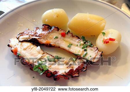 Stock Image - Octopus with boiled potatoes Portugal.. Fotosearch
