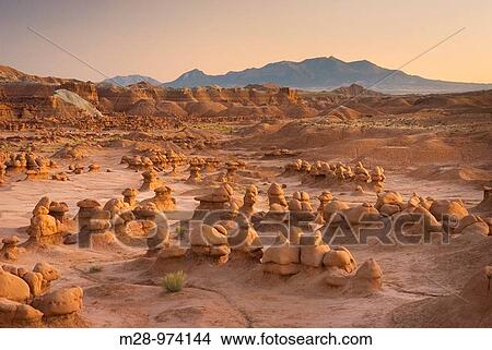 Odd shaped hoodoos of Entrada Sandstone illuminated in evening afterglow, Goblin Valley State Park Utah USA View Large Photo Image Picture - Odd shaped hoodoos of Entrada Sandstone illuminated in evening afterglow, Goblin Valley State Park Utah USA. Fotosearch