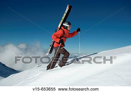 Off-piste skier climbing snow covered mountain with telemark skies View Large Photo Image Stock Photography - Off-piste skier climbing snow covered mountain with telemark skies. Fotosearch