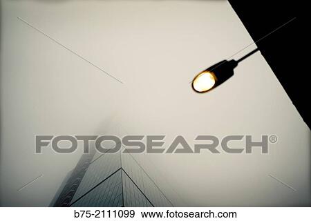 Office building in City of London, on a foggy day and a lighted street lamp. England, UK, Europe. View Large Photo Image Stock Photo - Office building in City of London, on a foggy day and a lighted street lamp. England, UK, Europe.. Fotosearch