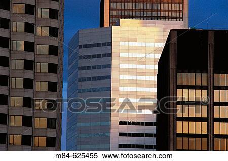 Stock Photography - Office buildings with sun reflecting in the windows. Fotosearch