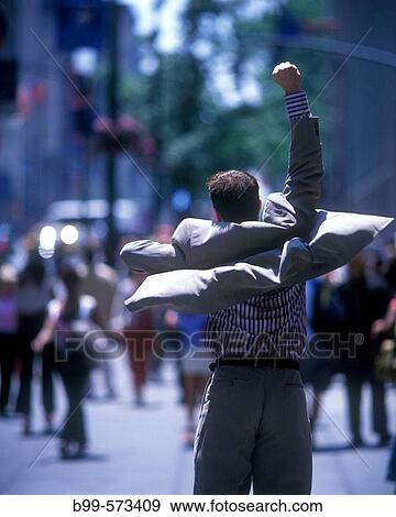 Stock Photo - Office worker jumps on fifth Avenue, Midtown, Manhattan, New York, USA. Fotosearch